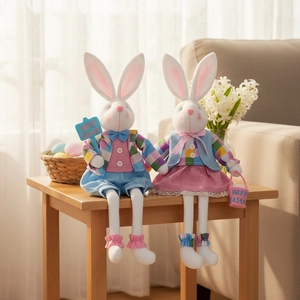 Pair of long-legged Easter bunny plush dolls with Happy Easter signs on a wooden table