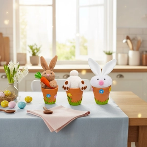 Three Easter bunny plush figurines in orange flower pots for festive home table decor