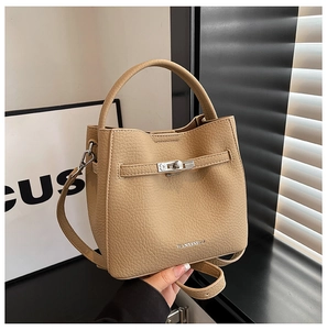 Detail of khaki bucket bag with lychee texture and silver twist lock closure