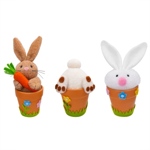 Three Easter bunny plush figurines in ceramic pots with colorful flowers and carrots