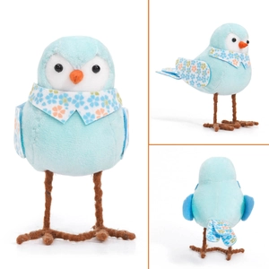 Detail of blue plush Easter bird figurine with floral collar and orange beak on wire legs
