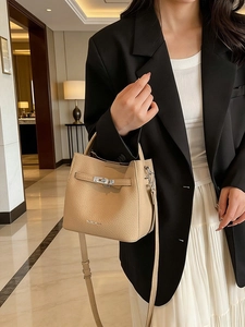 Retro beige pebble leather bucket handbag with silver turn-lock and adjustable shoulder strap