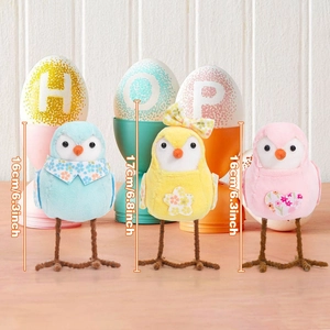 Detailed view of colorful plush Easter bird figurines with decorative collars and heart appliques
