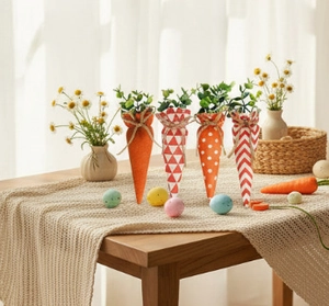 Detailed view of four orange fabric Easter carrots with various patterns on a wooden table