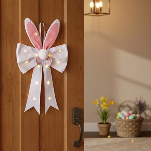 Lighted Easter rabbit ear bow decoration hanging on a wooden door with warm LED lights