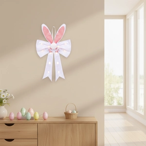 Light-up Easter bunny ear bow decoration with warm LED lights on a beige wall background