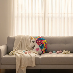 DIY plush unicorn decorative pillow with rainbow mane on a cozy sofa for bedroom decor