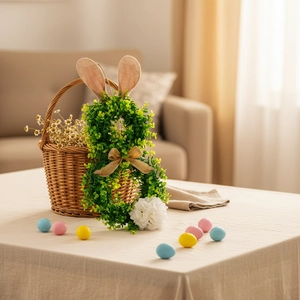 Easter rabbit greenery wreath with burlap ears and white pompom tail on a linen table