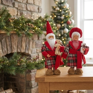 Detailed close-up of standing Santa and Mrs. Claus figures in festive red plaid outfits