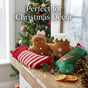 Christmas gingerbread plush dolls and knit stockings set on a festive fireplace mantel