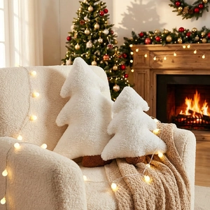 Sherpa Christmas tree pillows in two sizes set against a warm fireplace indoor backdrop