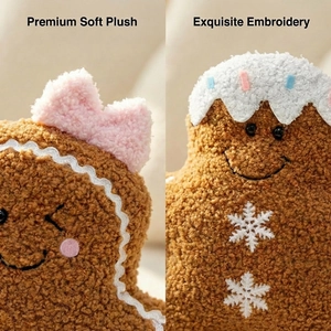 Detailed plush texture of gingerbread man pillow with snowflake embroidery and pink bow