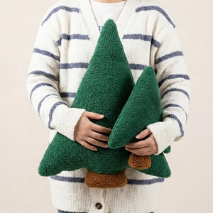 Sherpa fleece Christmas tree throw pillow in two sizes held for home decor display