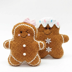 Plush gingerbread man Christmas pillows with cute embroidery on a clean white background