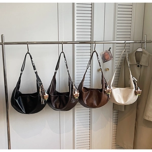 Detailed display of four crescent hobo bags in black, coffee, caramel and beige colors