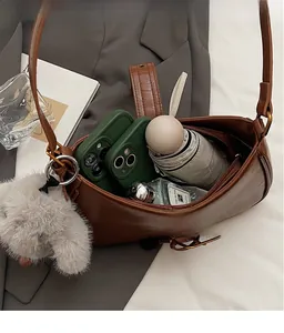 Internal view of the brown leather shoulder bag showing large capacity for daily items