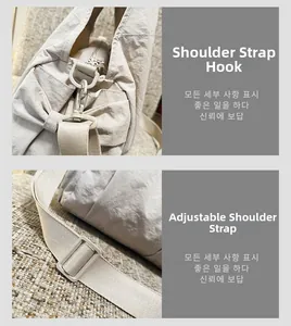 Detail view of the cream nylon tote bag featuring adjustable strap hooks and metal hardware