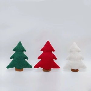Three plush Christmas tree pillows in green, red, and white sherpa fleece fabric