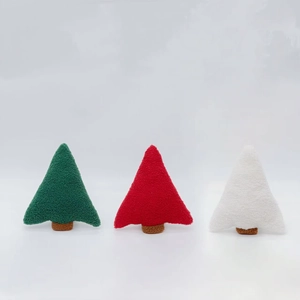 Three plush Christmas tree pillows in green red and white with soft fleece texture