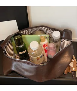 Interior view of brown faux leather hobo bag showing large capacity and striped lining