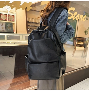 Side view of large black PU leather backpack showing main zipper and side pocket details