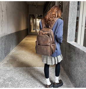 Brown PU leather backpack with vintage texture shown in an industrial corridor setting