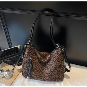 Detail of leopard print hobo bag with metal zipper and stylish tassel on the side