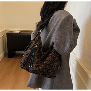 Detail of leopard print hobo bag showing large capacity and black leather tassel zipper