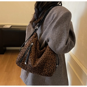 Macro shot of leopard print hobo bag with black leather strap and silver hardware accents