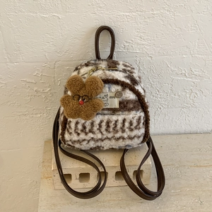 Detail of striped faux shearling mini backpack with bear charm and leather strap