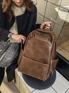 Large capacity dark brown PU leather backpack for men and women with minimalist design