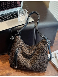 Leopard print crossbody tote bag with adjustable black strap and fringe detail