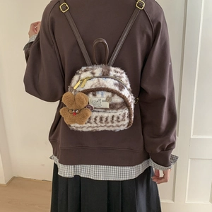 Detail view of plush backpack showing soft fur texture and cute bunny accessory