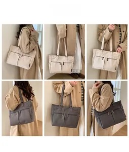 Detail view of large canvas tote bag with functional zipper pockets and side compartments