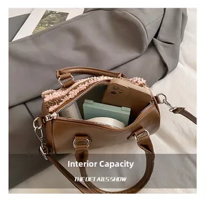 Detailed view of the internal capacity of a brown faux leather boston handbag