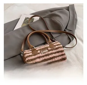Detail showing pink and coffee plush striped pillow bag with LOVE tag and brown leather handles