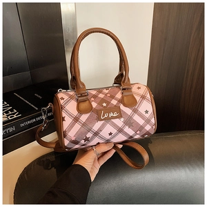 Close-up of pink plaid Boston bag with star prints, leather handles, and Love logo