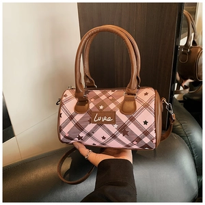 Detail view of pink plaid pillow bag with embroidered Love script and star patterns