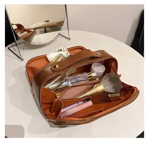 Detail of caramel brown crocodile faux leather travel organizer with multiple compartments