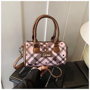 Detail of pink plaid cylinder bag with star patterns and Love embroidery patch