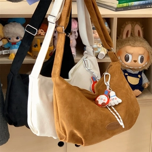 Detailed view of matte suede hobo bags with adjustable straps in three colors