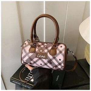 Close-up of pink and brown checkered Boston bag with star print and Love patch