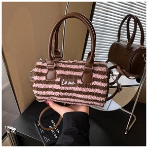 Detailed view of the pink-brown striped plush material and leather Love patch