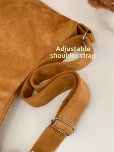 Detail showing the adjustable wide matte leather shoulder strap with a silver metal buckle