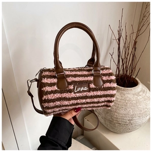 Detail of striped plush Boston bag featuring leather Love patch and metal hardware