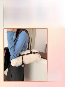 Detail of cream sherpa plush cylinder bag with dark brown leather straps for autumn fashion