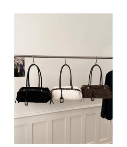 Detailed view of lamb wool tote bags in black, white, and brown with leather straps