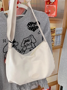 Versatile cream half-moon tote bag with adjustable wide strap for casual daily commuting