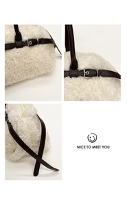 Detail of white faux fur tote with brown leather straps and silver buckle closure