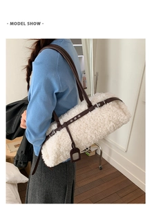 Detail of off-white faux fur tote bag with brown leather straps shown on a model